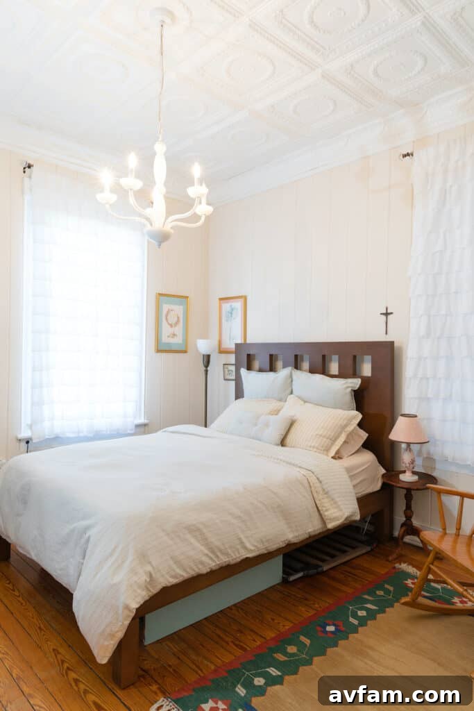 Richmond Restoration: A Historic House Reborn 9 After renovation: Bright girls' bedroom with a white tin ceiling and cream walls in a Richmond VA home