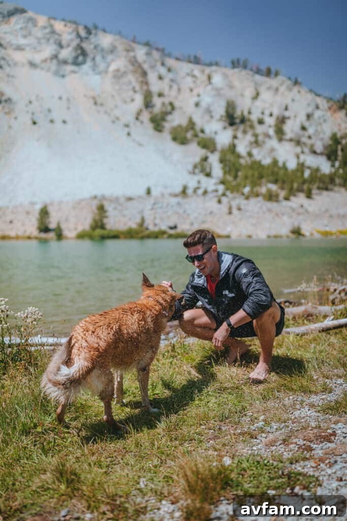 Adventurer wearing a Jack Wolfskin jacket and backpack, standing in a rugged outdoor landscape with mountains in the background, showcasing durable and functional outdoor apparel.