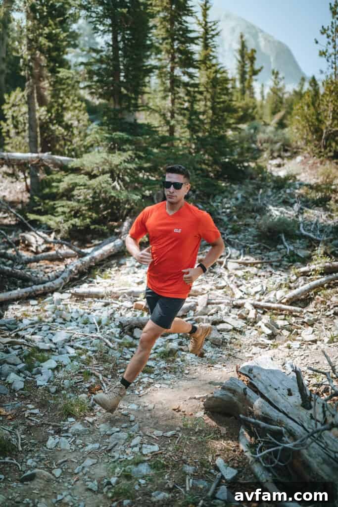 A person in Jack Wolfskin gear navigating a rocky, uphill path, emphasizing the durability and flexibility of the clothing for challenging hikes.