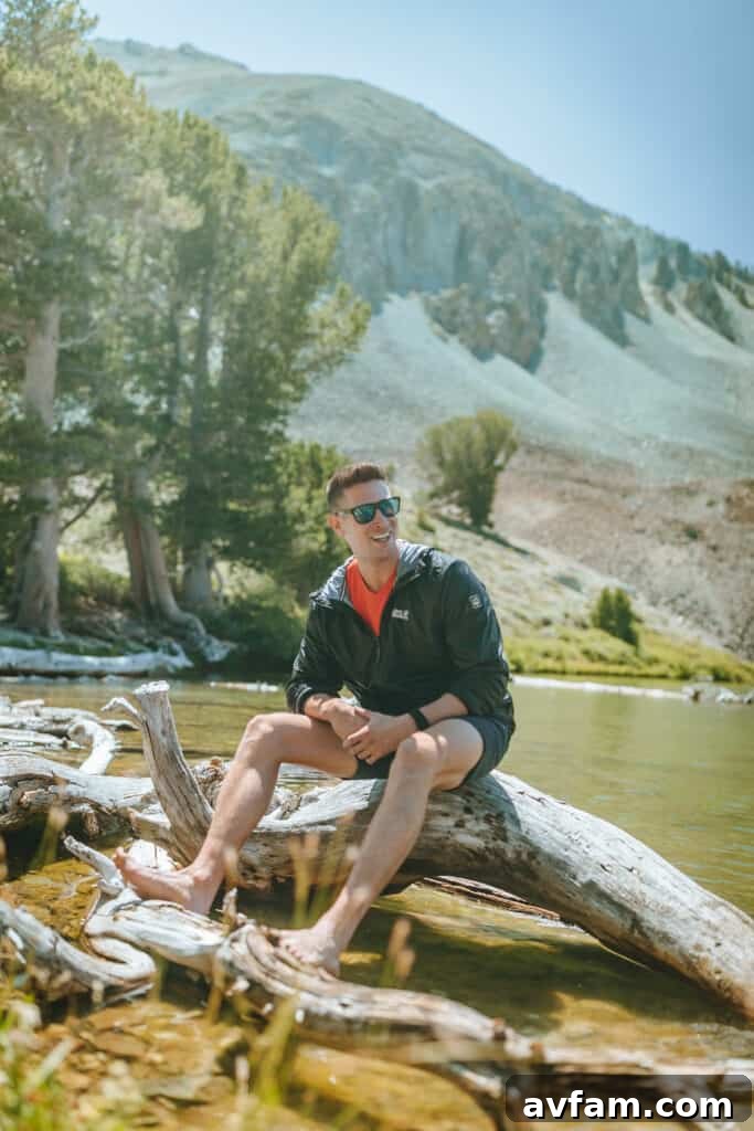 A detailed shot of a person's legs and hiking boots, with Jack Wolfskin trousers, traversing uneven terrain, highlighting the gear's suitability for rugged outdoor activities.