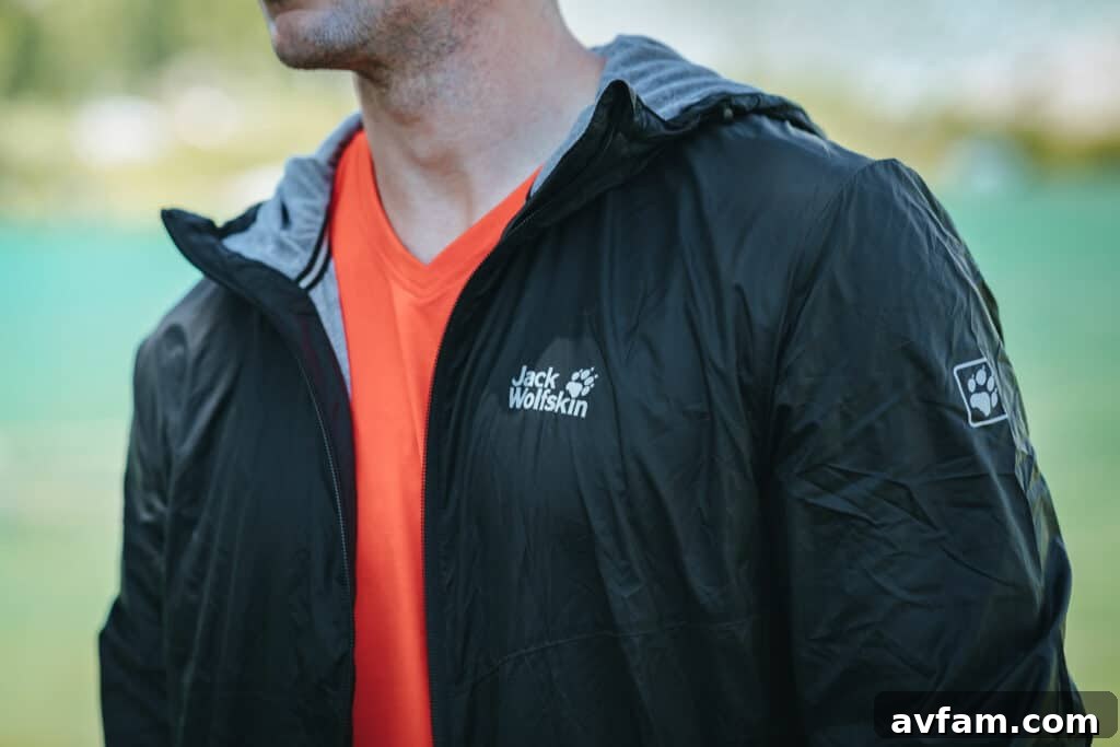 Two adventurers, one in Jack Wolfskin clothing, interacting joyfully in an open natural space, emphasizing shared outdoor experiences and durable gear.