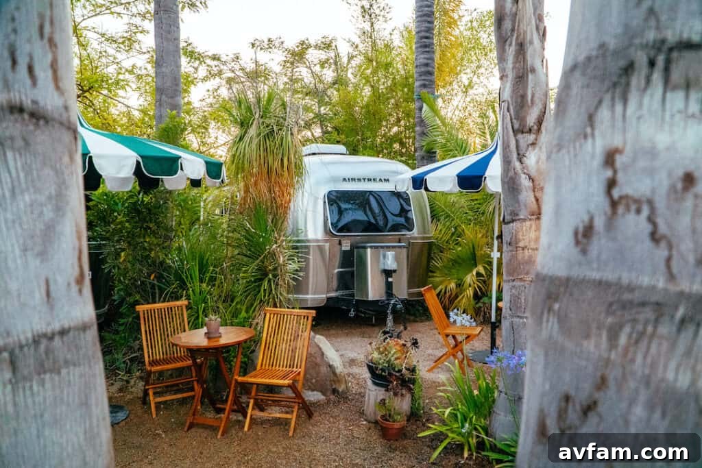 A pristine silver Airstream trailer gleaming under the Ojai sun, ready for a luxurious glamping adventure.