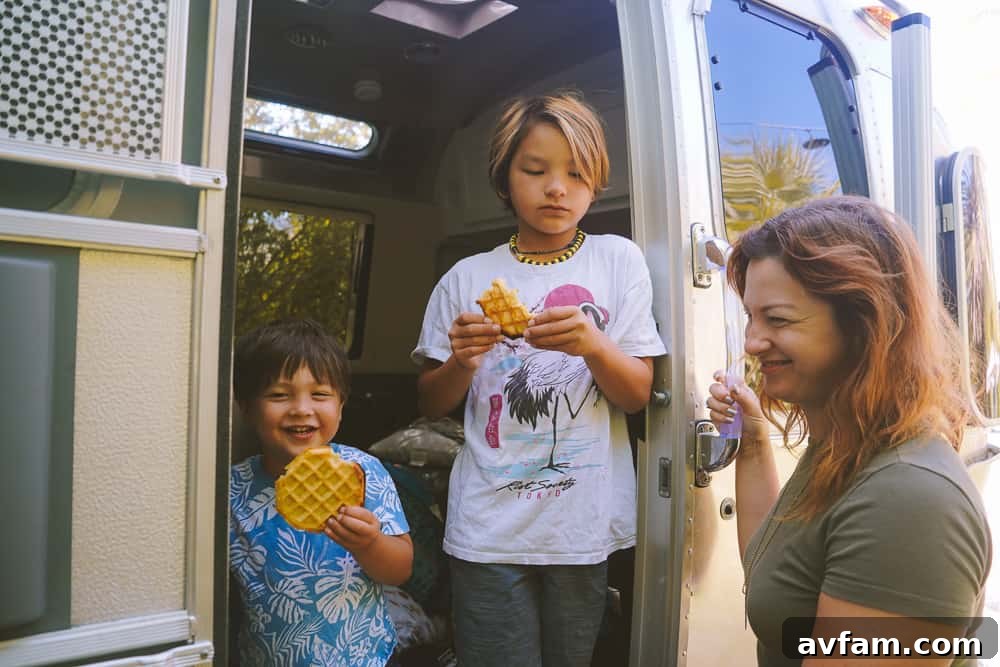 A well-equipped kitchen inside the Airstream, featuring a sink, stovetop, and oven.