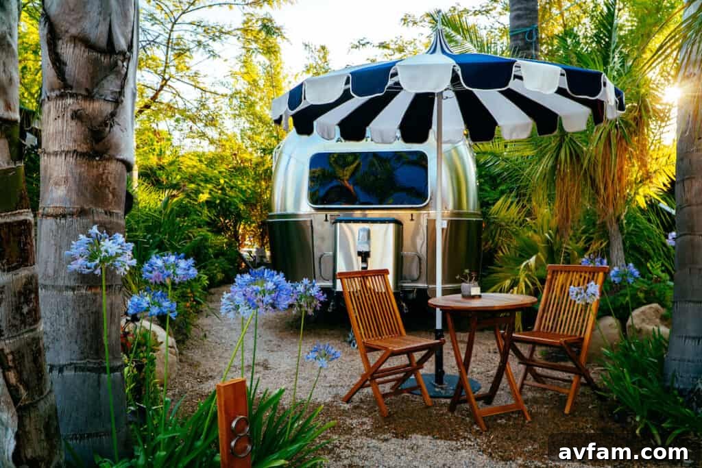 The exterior of an Airstream trailer at Caravan Outpost, surrounded by nature.