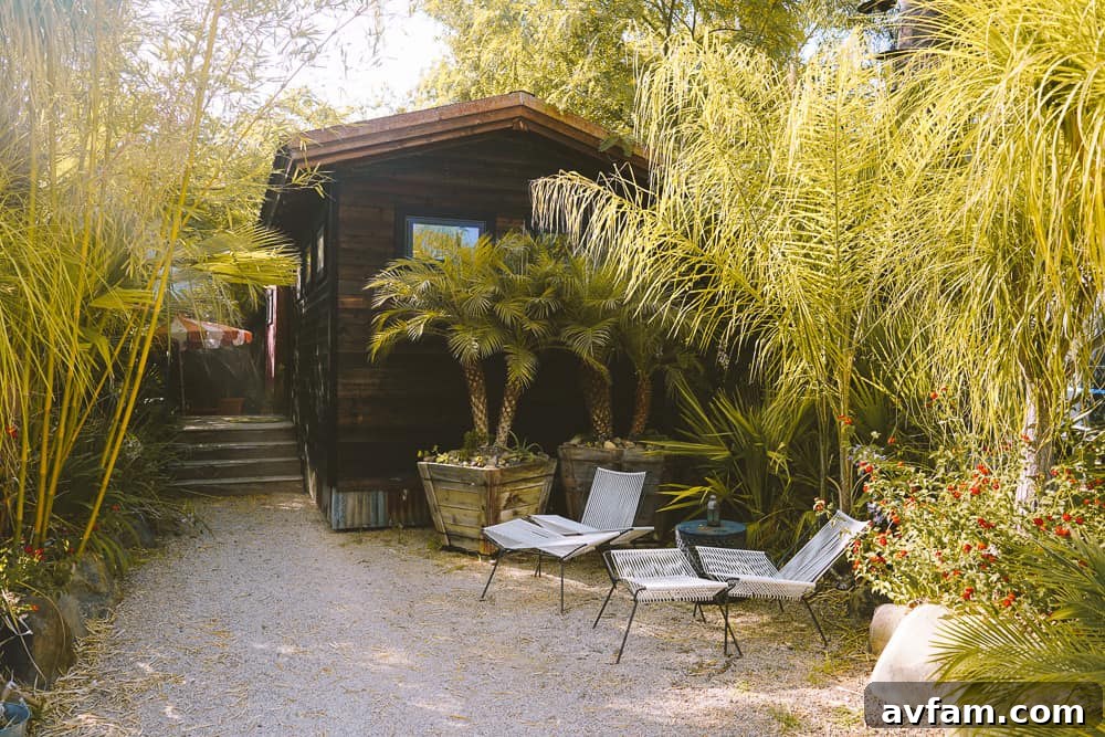 The entrance to Caravan Outpost, showcasing an inviting outdoor living space with unique glamping units.