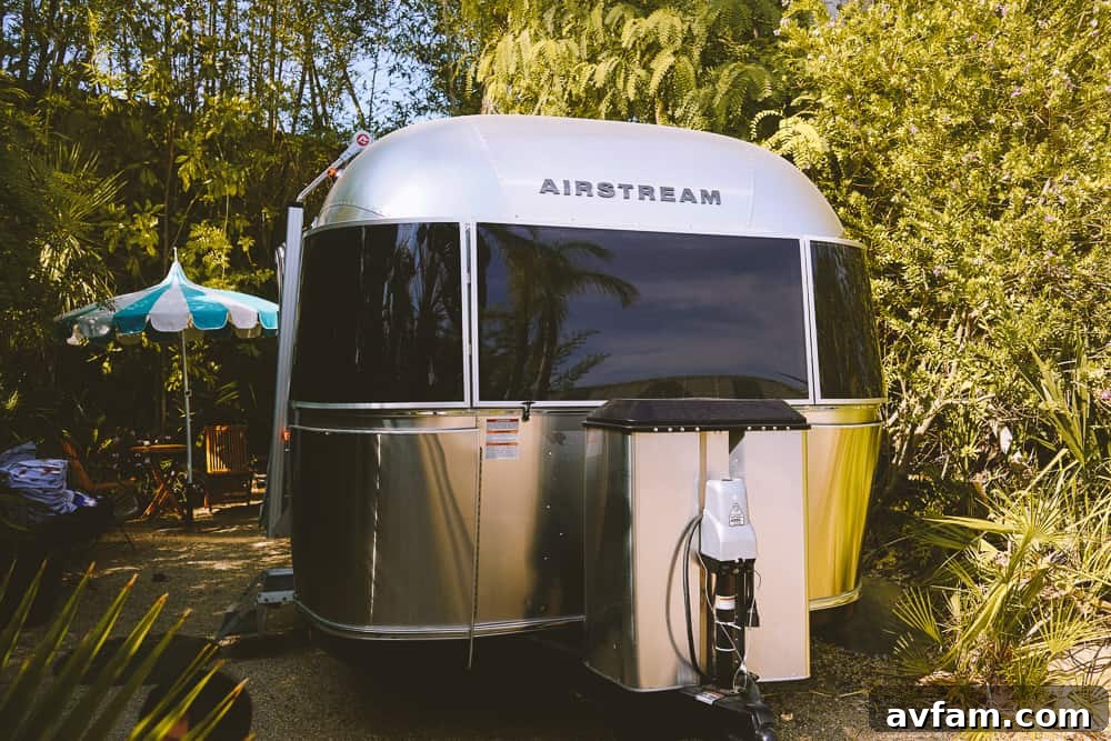 The reflection of the sky on the polished surface of an Airstream trailer.