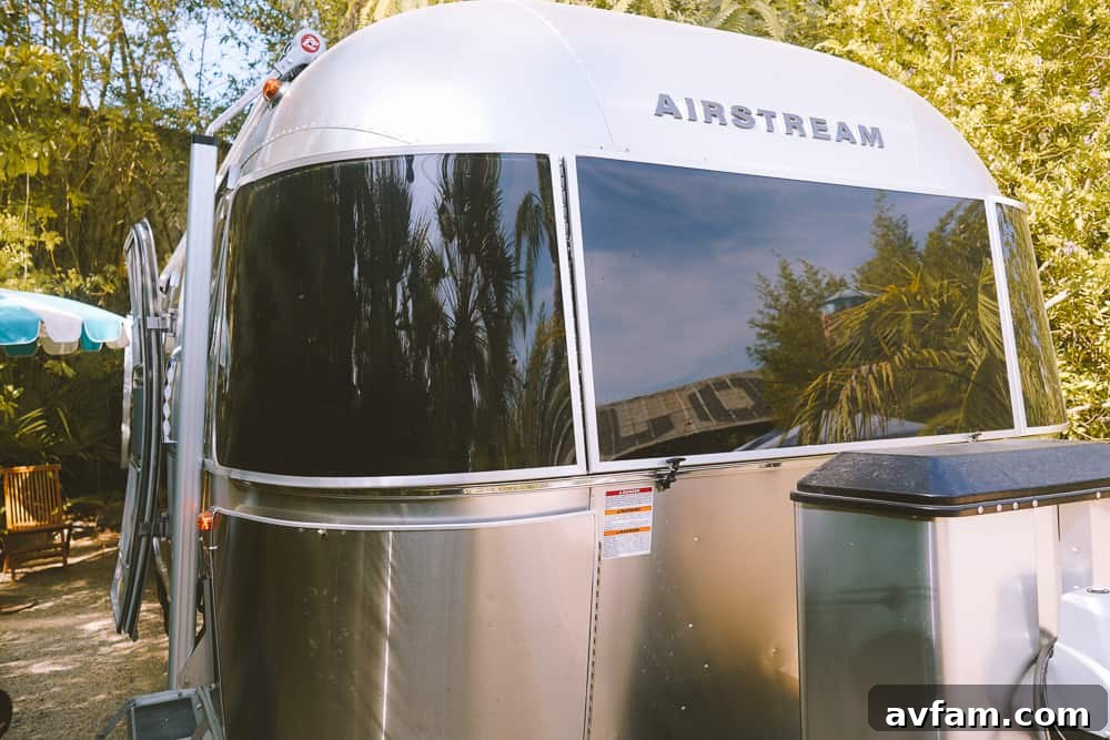 A vibrant green landscape surrounding the Airstream, highlighting the connection to nature.