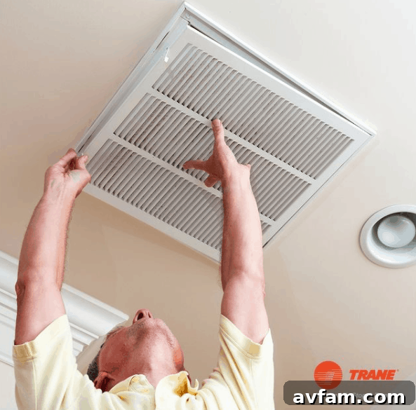Measuring an HVAC air filter to determine the correct replacement size.
