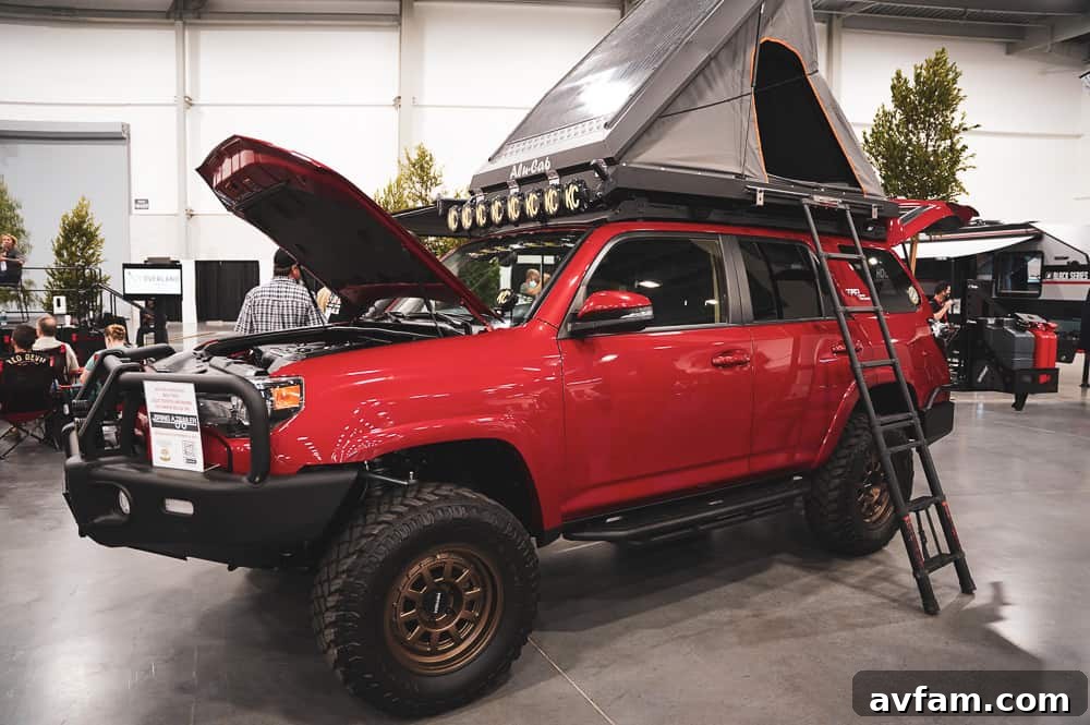 A powerful custom Jeep Wrangler, equipped for extreme off-roading with specialized tires and body armor.