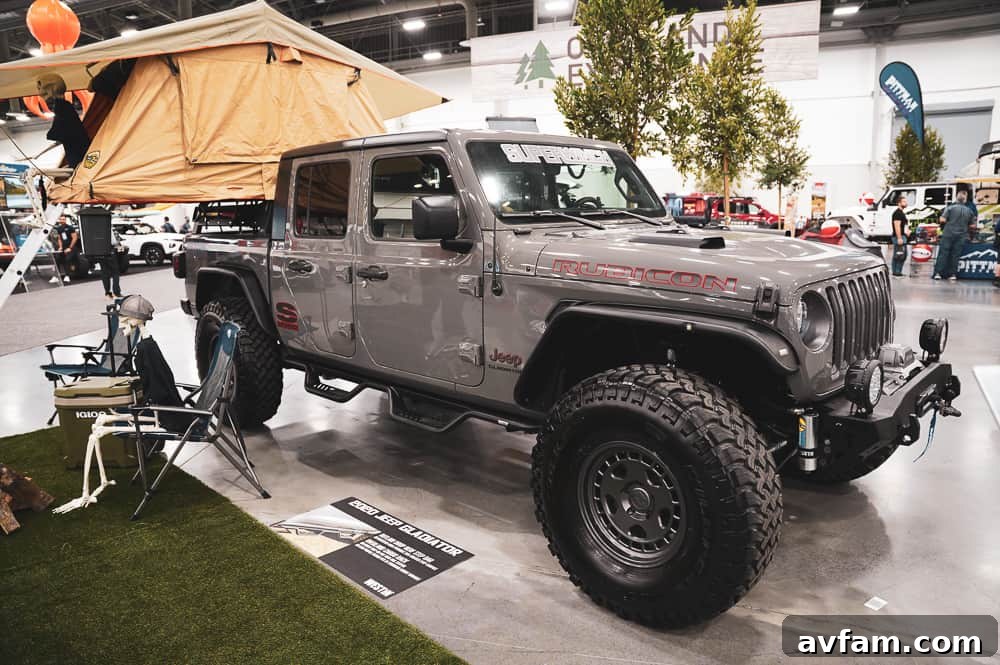 A striking blue custom Ford F-Series truck with a massive lift kit and elaborate grille design at SEMA.