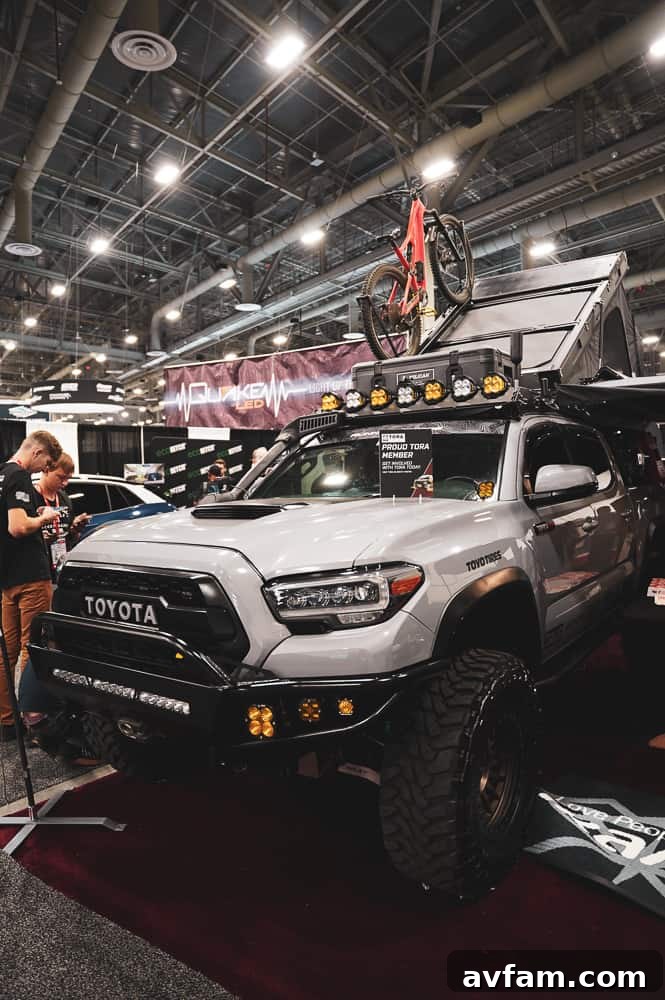 A custom off-road vehicle with a unique camouflage wrap and extensive exterior protection accessories.