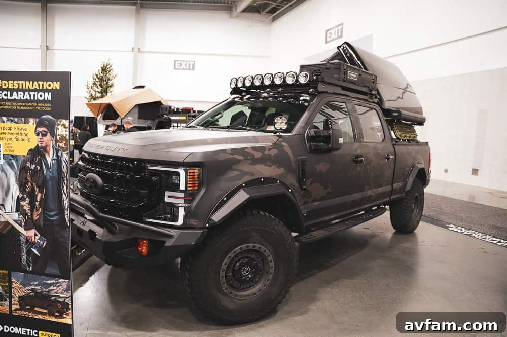 A row of diverse custom vehicles, including trucks and SUVs, showcasing various aftermarket accessories at SEMA.