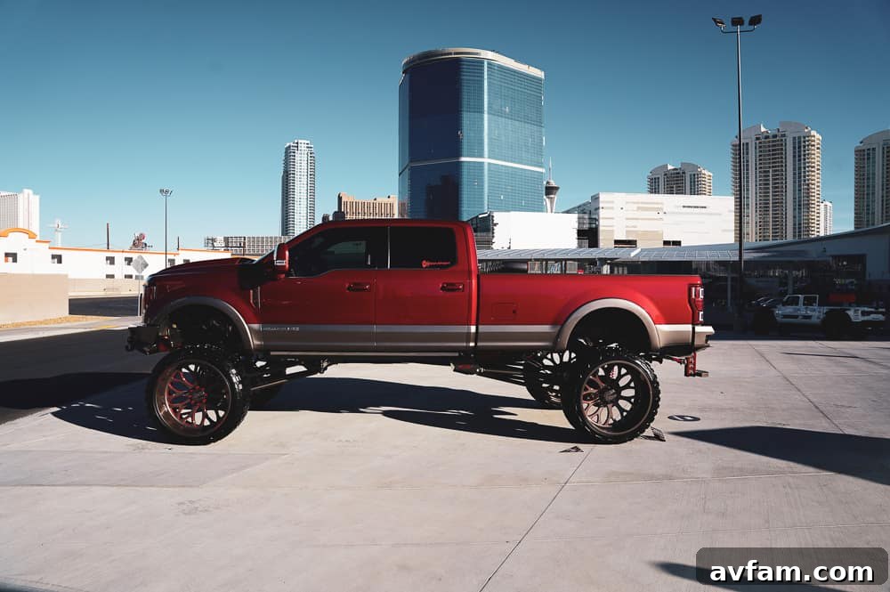 A custom full-size pickup truck with a vibrant custom wrap and large aftermarket wheels, capturing attention.