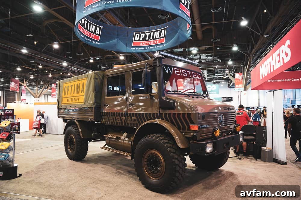 A custom off-road vehicle with robust body armor, aggressive tires, and a powerful winch for recovery.