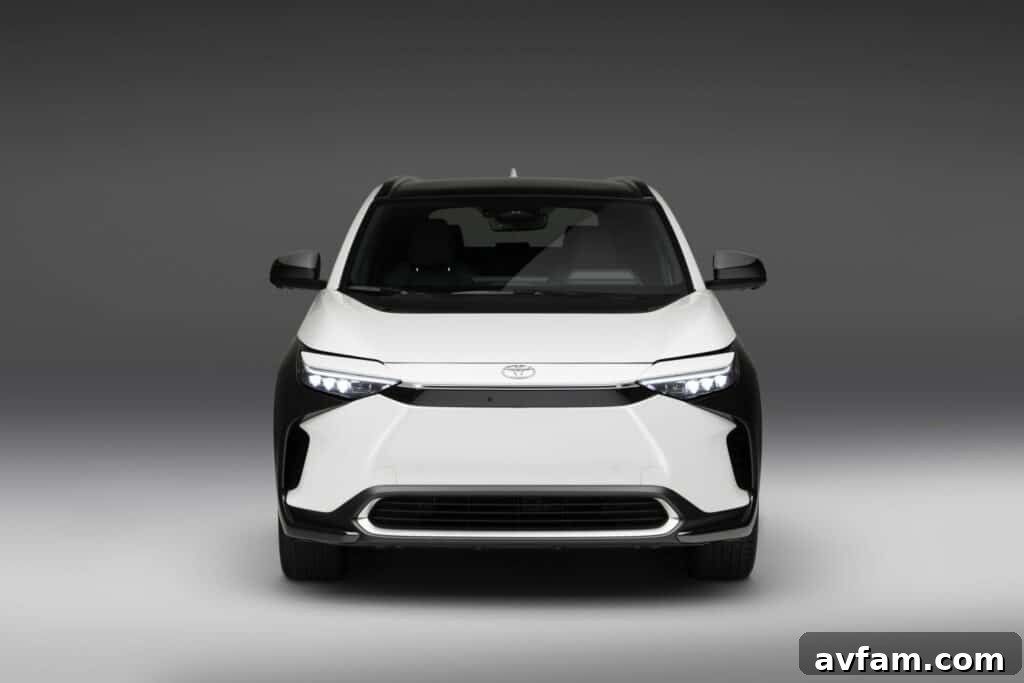 Rear profile of the Toyota bZ4X, showcasing its integrated spoiler and distinct tailgate