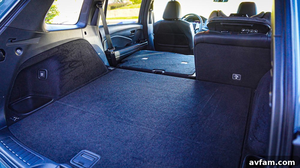 Honda Passport Driving The 2022 Honda Passport driving on a road, highlighting its dynamic silhouette.