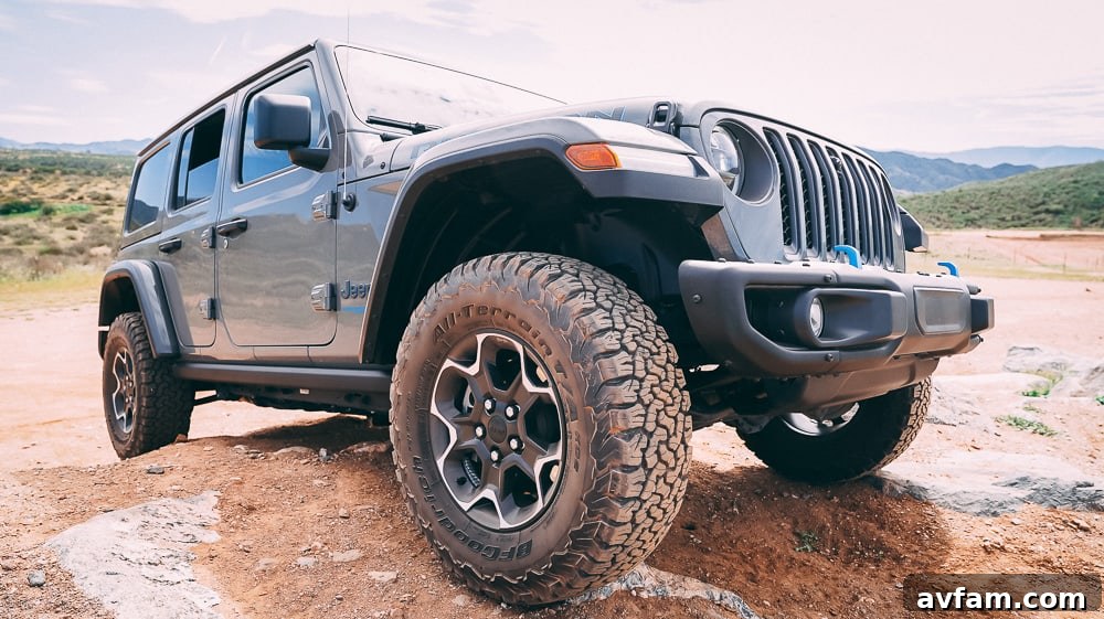 Jeep Wrangler 4XE Silent Trailblazer 16 Front view of the Jeep Wrangler 4XE highlighted by sunlight on an open trail.