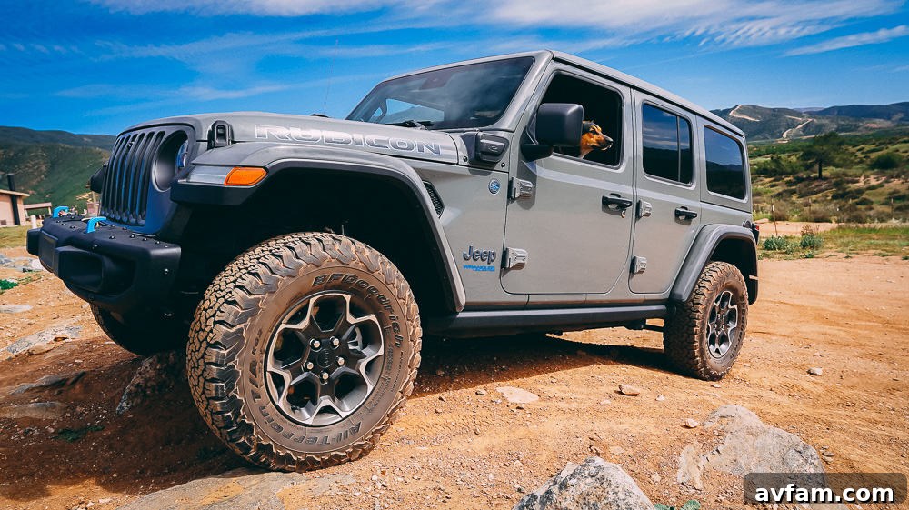 Jeep Wrangler 4XE Silent Trailblazer 20 Jeep Wrangler 4XE with its doors off, parked in a scenic outdoor setting.