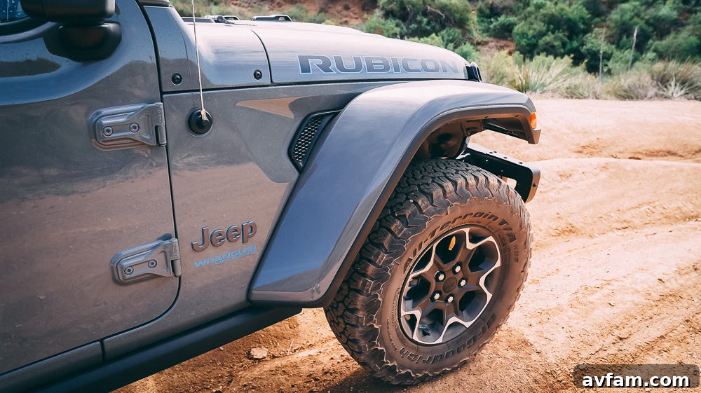 Jeep Wrangler 4XE Silent Trailblazer 24 Rear profile of the Jeep Wrangler 4XE driving away on a trail at sunset.