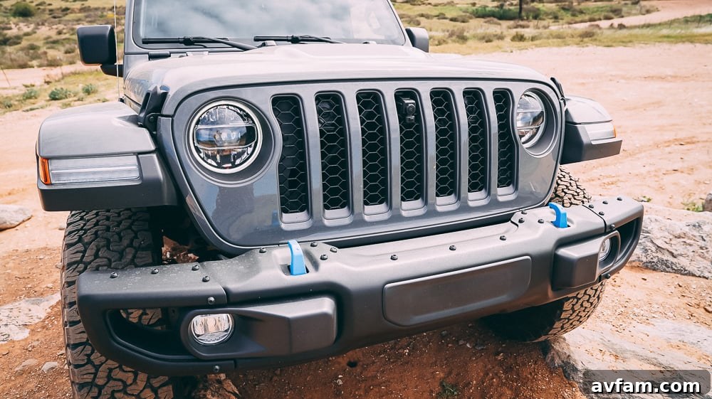Jeep Wrangler 4XE Silent Trailblazer 27 The distinct front grille of the Jeep Wrangler 4XE, ready for adventure.