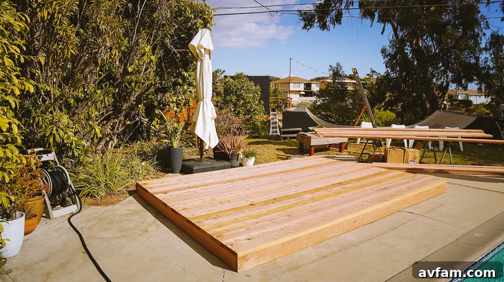 Completed redwood deck with outdoor furniture and decor, showcasing its transformation