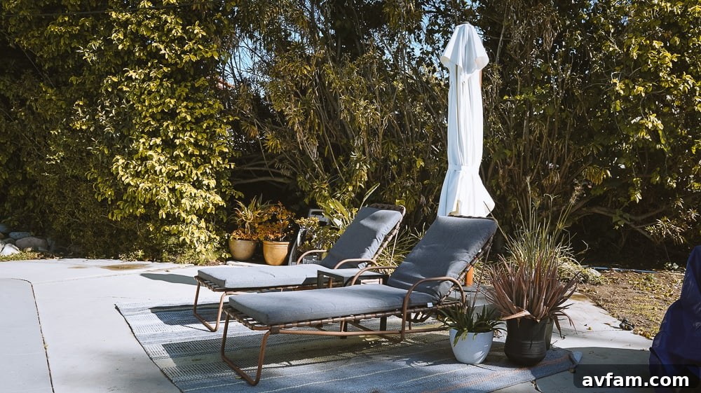 Close-up of the existing concrete patio with an outdoor rug, showing its current condition