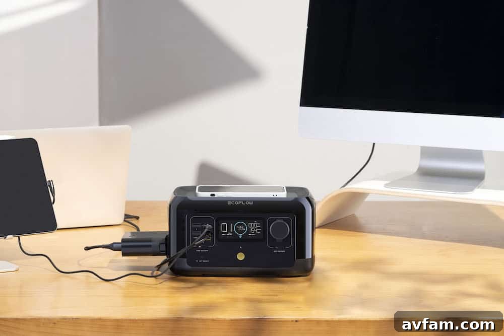EcoFlow RIVER mini portable power station in the trunk of a vintage Land Cruiser, providing power for various electronic devices.