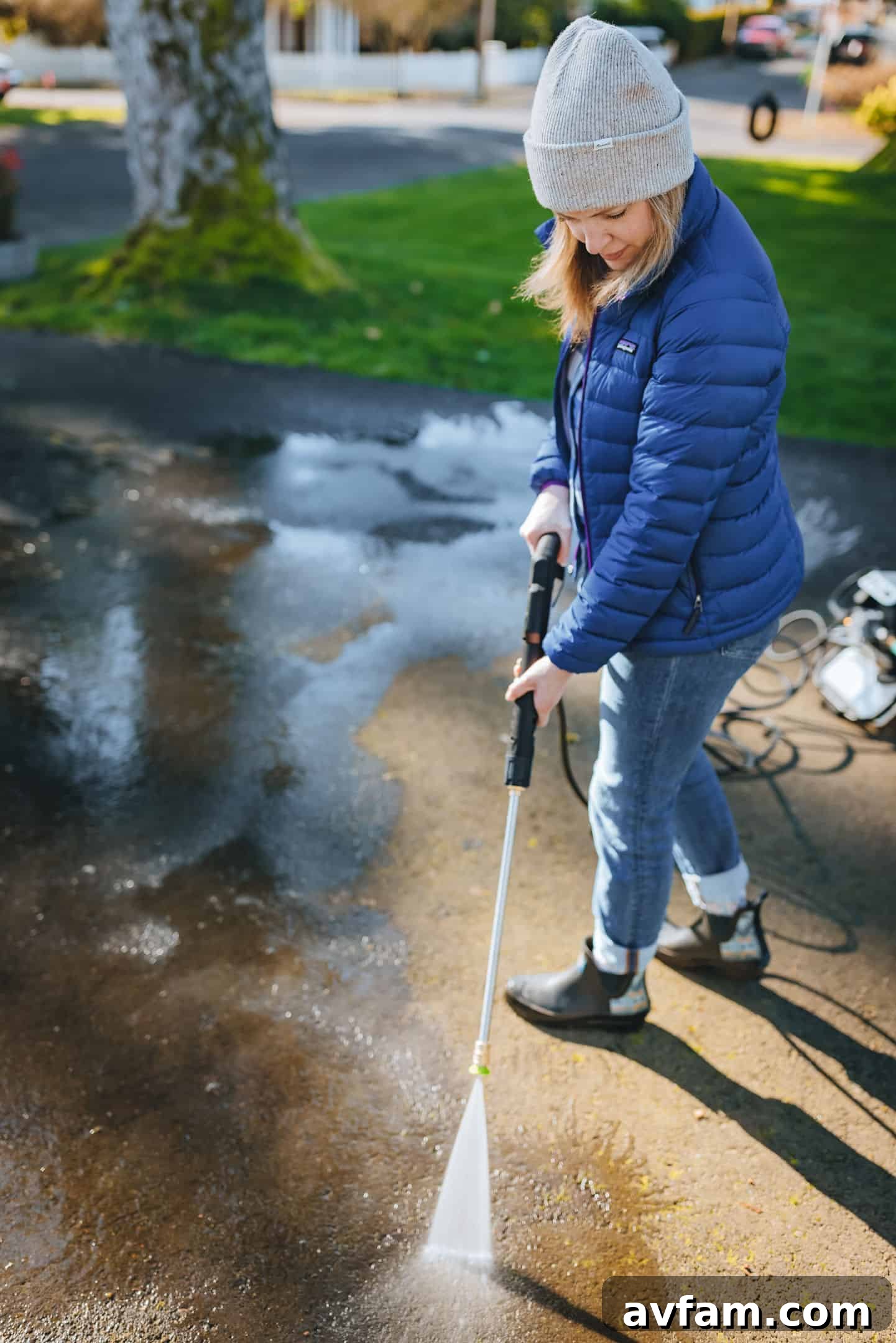 Worx pressure washer in action, demonstrating the wide spray pattern of a particular nozzle on a large surface.