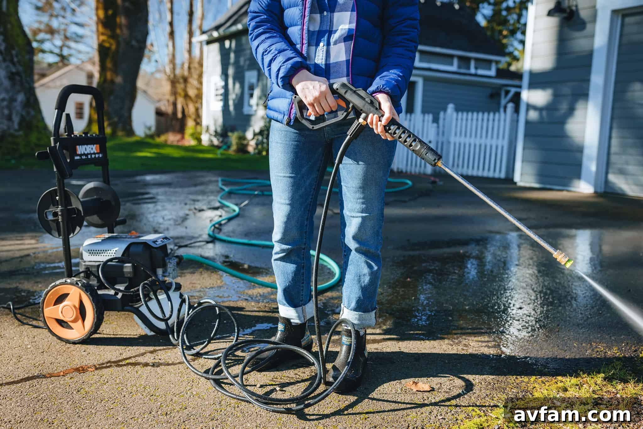 Worx 2000 PSI pressure washer cleaning a large concrete driveway, effectively removing dirt and stains.