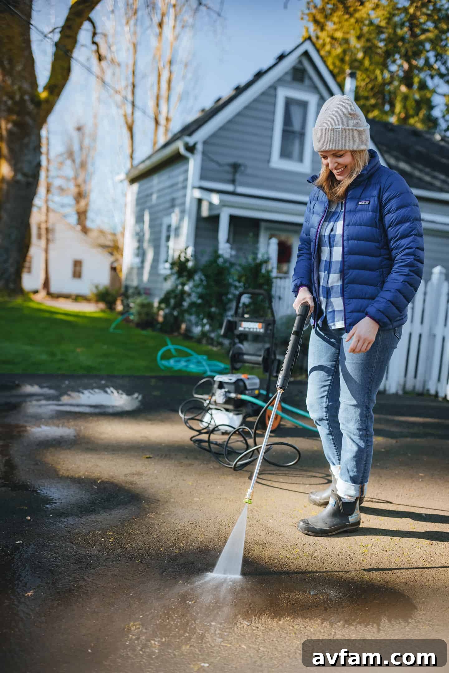 Steve Makowski demonstrating the portability of the Worx pressure washer with its built-in wheels.