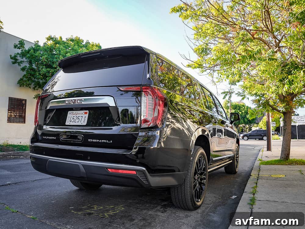 GMC Yukon XL Denali parked on an urban street, showcasing its imposing size