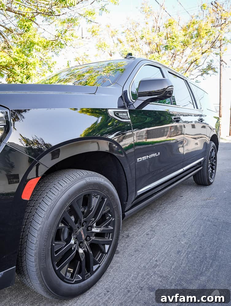 GMC Yukon XL Denali side mirror and door handle close-up with chrome accents