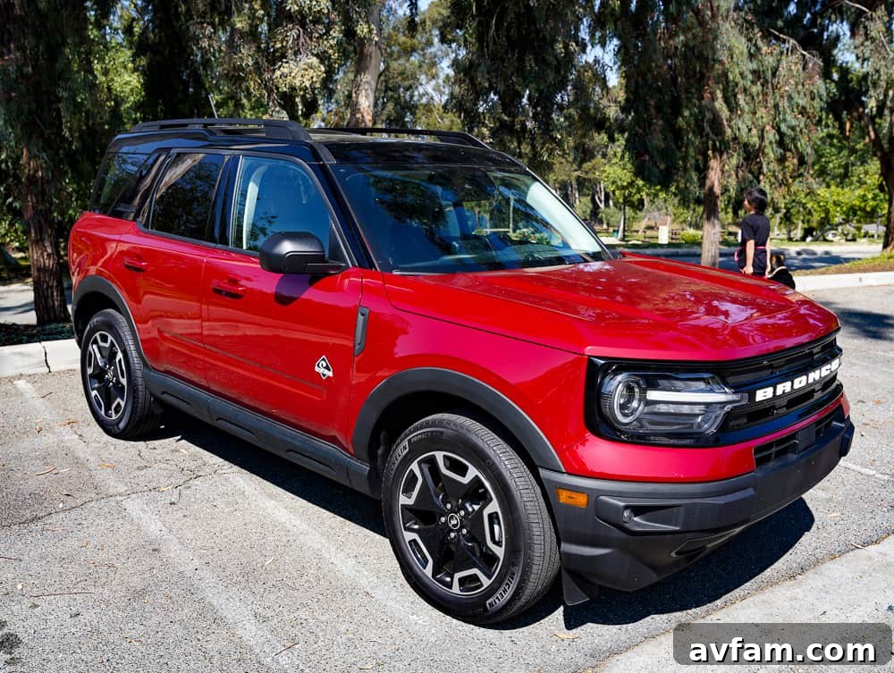 Front three-quarter view of the Ford Bronco Sport Outer Banks in Rapid Red metallic, parked in an outdoor setting.