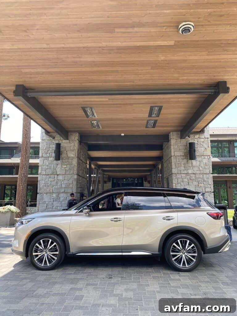 Edgewood Tahoe resort with the Infiniti QX60 parked nearby, overlooking Lake Tahoe.