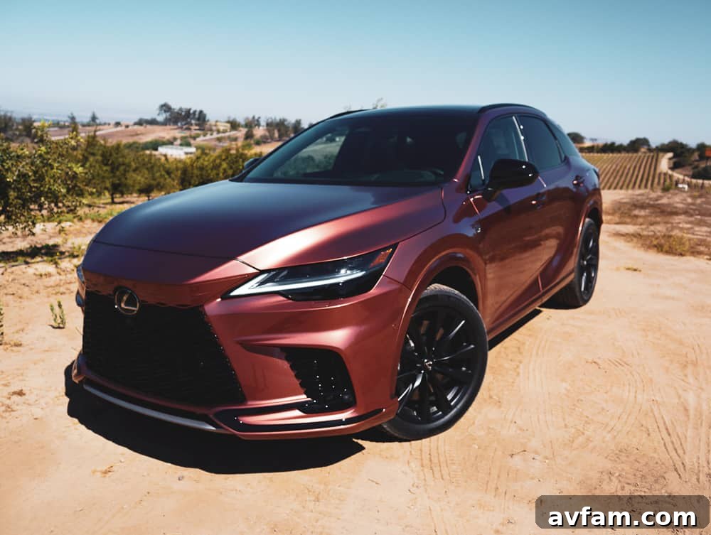 2023 Lexus RX 500h F Sport Performance in Copper Crest exterior front view on a scenic road.