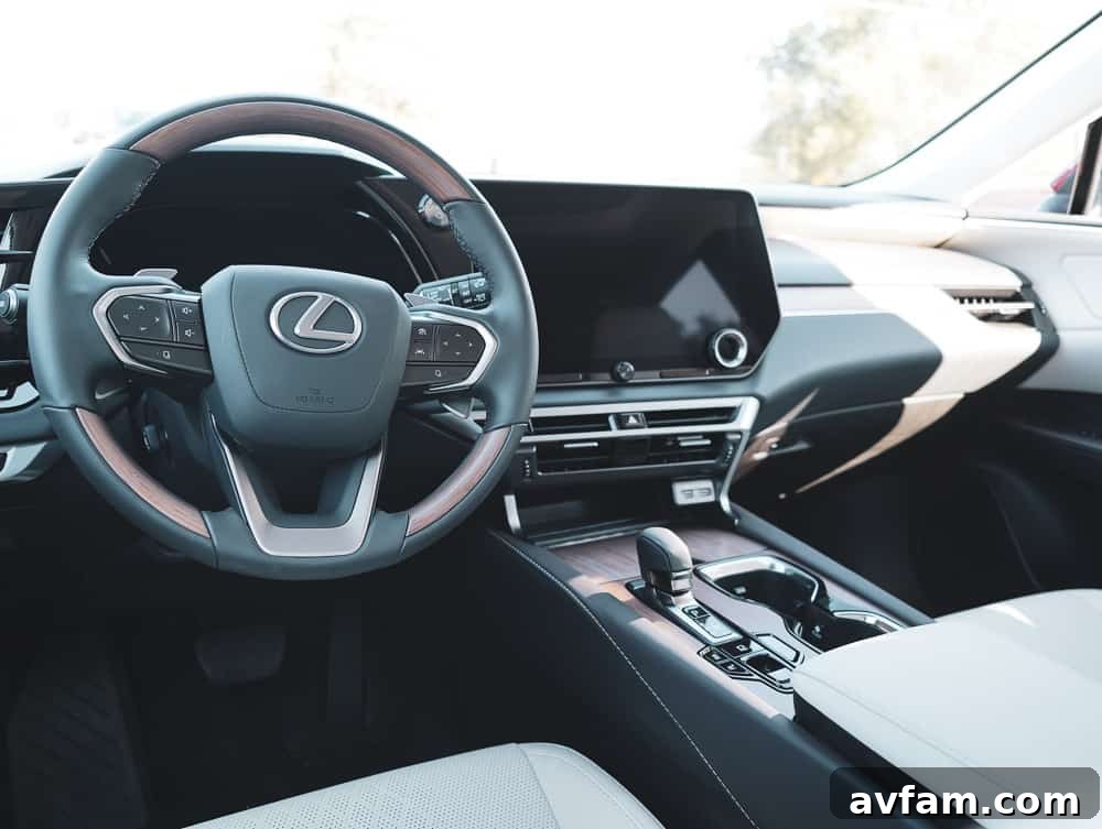 2023 Lexus RX 500h F Sport Performance driving through vineyards in Copper Crest color.