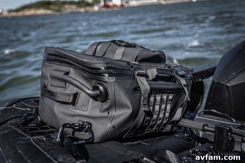 Pro Stealth 50L supporting an adult Subtech Pro Stealth 50L Drybag being used as a floatation device with an adult in water.