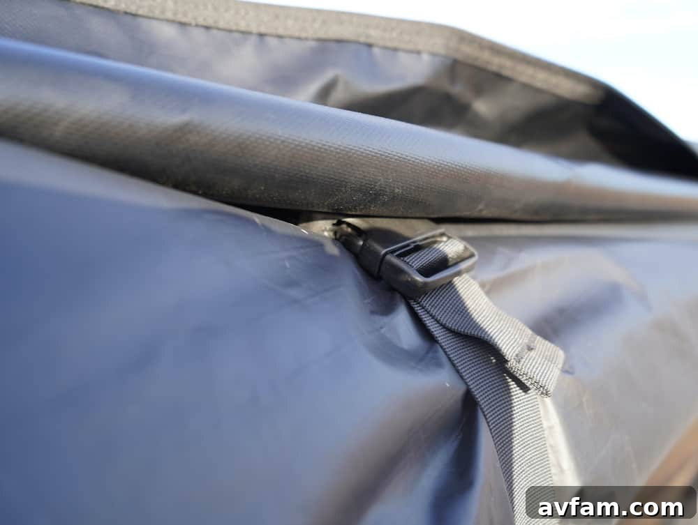 Person unzipping the protective travel cover of the Roam ARC 270 awning