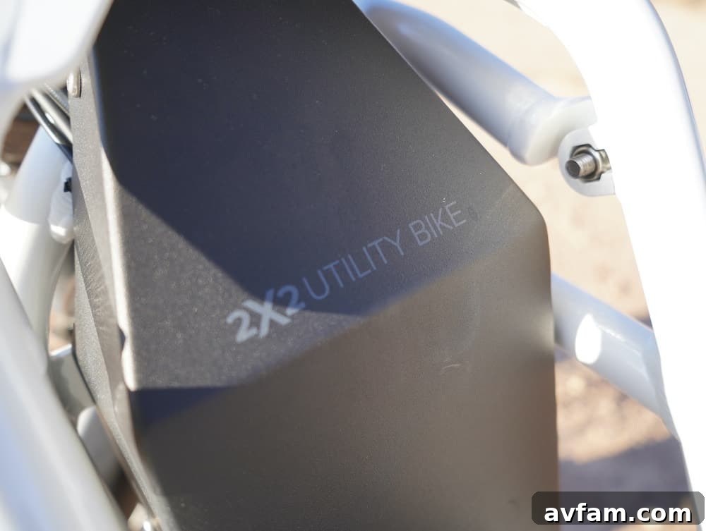 UBCO 2x2 electric bike carrying gear on a dirt road