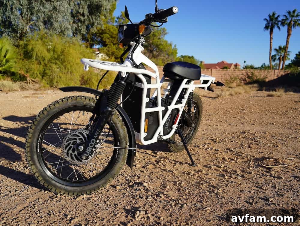UBCO 2x2 electric bike exploring a remote dirt road with mountains in background