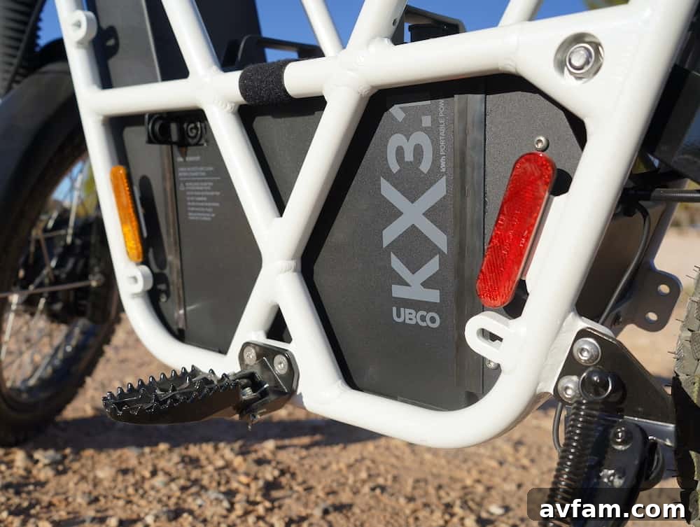 UBCO 2x2 electric bike on a dirt track under a cloudy sky