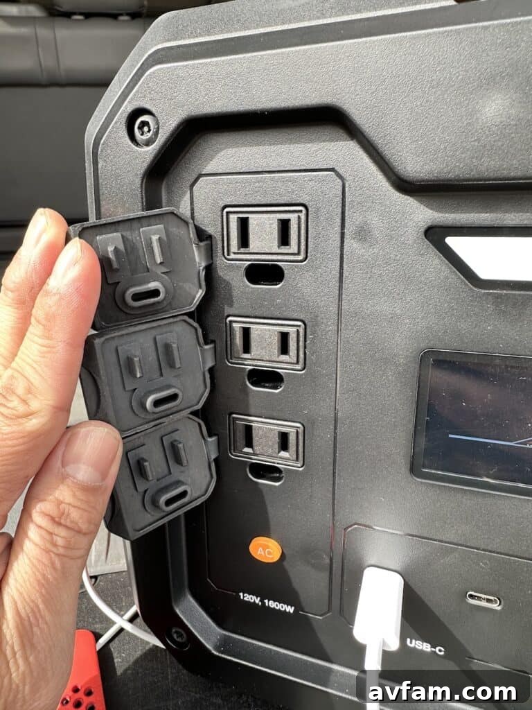 Generac GB1000 with various ports and a phone charging wirelessly.