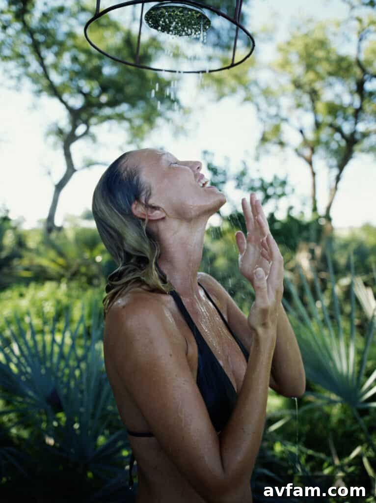 A luxurious outdoor shower with natural wood and lush greenery, embodying a spa-like oasis for relaxation.