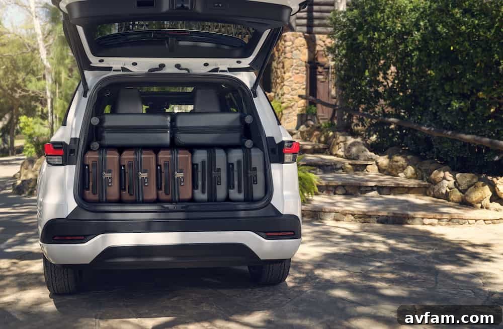 Rear view of the 2024 Lexus TX with the tailgate open, showcasing ample cargo space.
