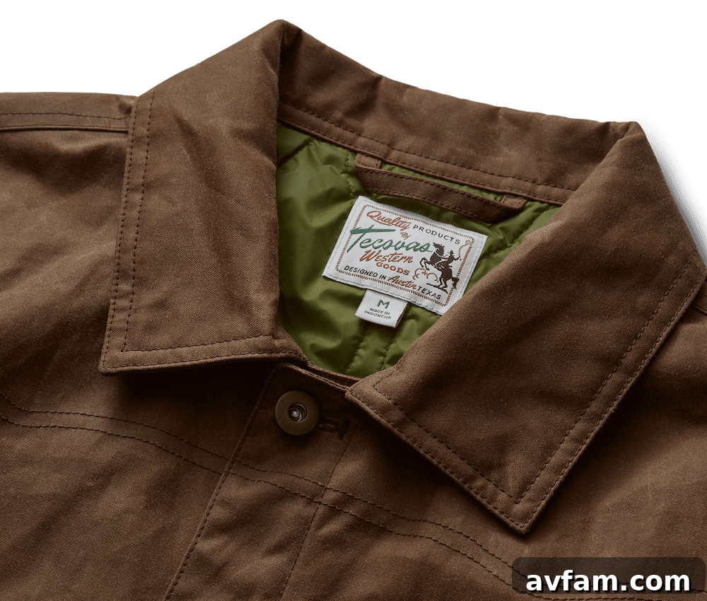 Tecovas Men's Buckaroo Waxed Canvas Trucker Jacket Tecovas Men's Buckaroo Waxed Canvas Trucker Jacket in Tobacco color, front view with a Western landscape background.