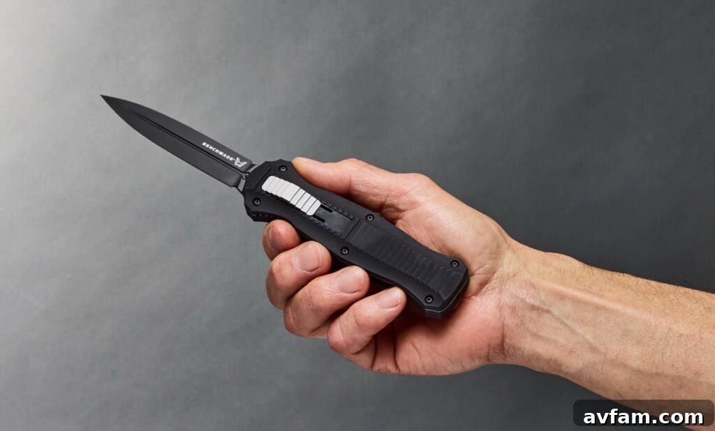 The Mechanics of OTF Knives OTF knife blade deployed from the handle, showcasing its out-the-front mechanism.