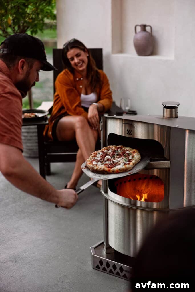 Overhead shot of a delicious pizza being prepared on a serving board before going into the Breeo oven.