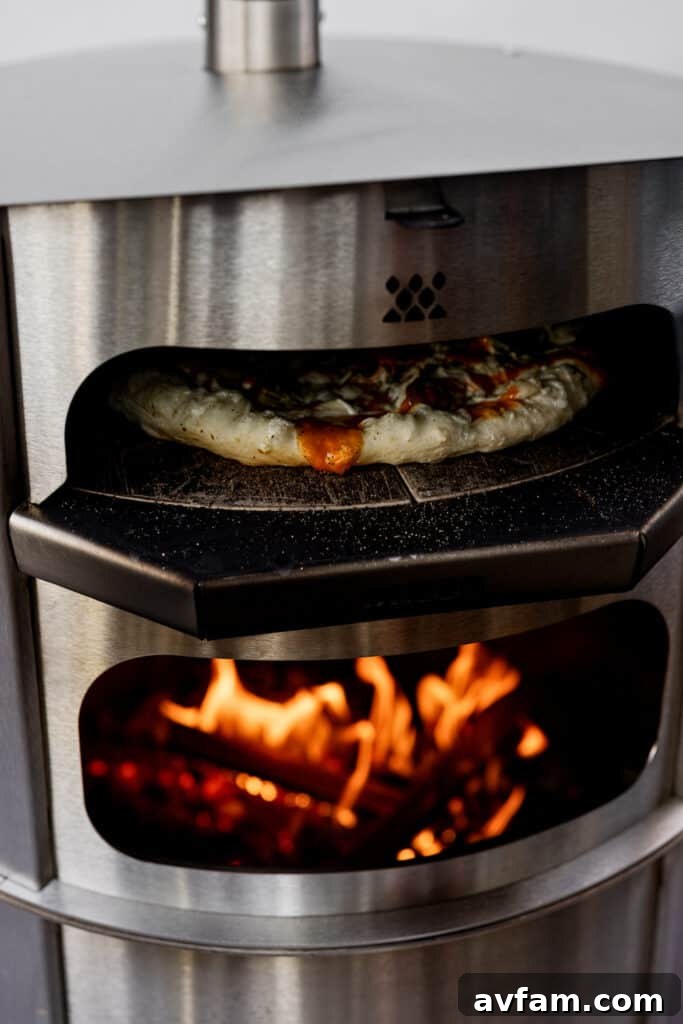 Close-up of bubbling cheese and crispy crust in the Breeo Live-Fire Pizza Oven.