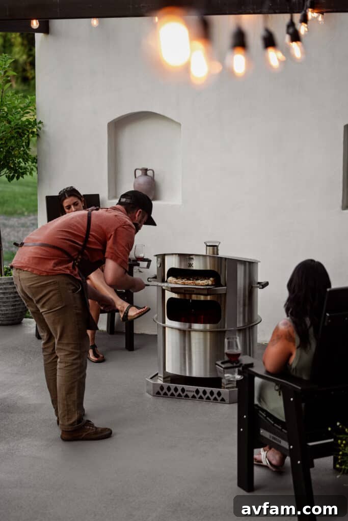 A perfectly cooked pizza emerging from the Breeo Live-Fire Pizza Oven, ready to be served.
