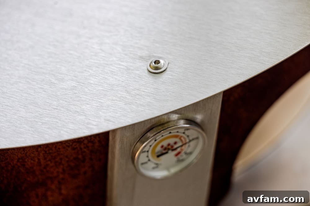 A person placing wood into the Breeo X24 fire pit, ready for cooking or warmth.